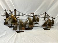 Full view of the wall hanging showing all sailboats and the bridge against white background.