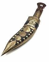 Front view of the kukri in its leather sheath with brass embellishments and coins.