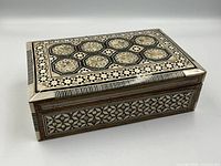 Angled view of the rectangular jewellery box showing mosaic design on top and side panels.