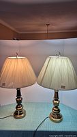 Two metal table lamps side by side with fabric shades, showing size and style