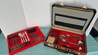Full view of the open original box containing various cutlery pieces inset in red holder.