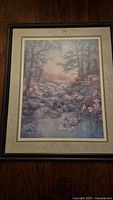 Full view of the wood framed picture featuring a natural creek scene with blooming trees and rocks.