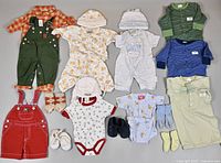 Full set of baby clothes and accessories laid out on floor for inventory and condition assessment