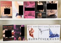 Photo of 10 adult romance novels by Maya Banks arranged on a white shelf, titles visible with cover art featuring couples and artistic imagery.