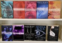 Front covers of 10 adult romance novels by Shayla Black (9) and Delilah Devlin (1) arranged in two rows on a flat surface.
