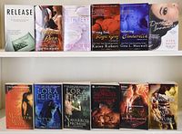 Photo of 12 fantasy fiction and romance novels with covers visible, showing titles and authors.