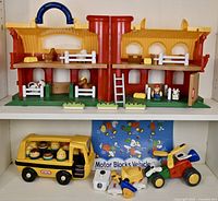 Full lot overview showing Play Farm on top shelf with animals and accessories, Little Tikes School Bus with peg dolls, and Tomy Motor Blocks vehicle pieces with instruction sheet below.