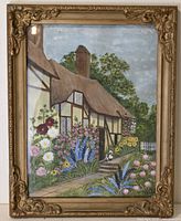 Front view of the entire painting showing the cottage and garden scene in a gilt ornate frame.