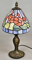 Full view of the vintage mini Tiffany style table lamp showing colorful floral stained glass shade and antique bronze base.