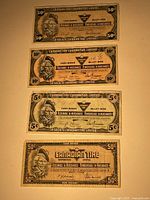 Photo of four Canadian Tire Money banknotes from the 1980s, denominations include 50¢, 10¢, 5¢, and another 50¢ cash bonus note.