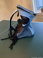 Side view of the Pet Ami rodent carrier backpack showing mesh ventilation panels and adjustable straps.