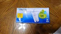 Box of 5 Brita water filter cartridges on wooden table