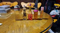 Full view of five women's perfume bottles on table