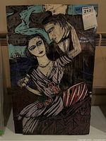 Front view of the rectangular handmade mosaic artwork depicting a couple in stylized poses with muted earth tones and teal highlights, mounted on wood.