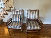Two wooden chairs side by side, one rocking chair, both with striped fabric upholstery.