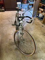 Vintage Centurion bicycle, front view showing frame, drop handlebars, and front wheel with tire.