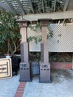 Front view of two tall outdoor patio heaters, showing height and general shape