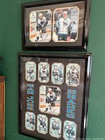 Two framed Sharks memorabilia pieces hanging on a green wall. Larger frame holds multiple signed cards/photos arranged with San Jose Sharks text, smaller frame holds two large signed photos.