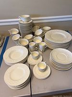 Overview of the entire Wedgwood Patrician China set showing plates, cups, saucers, and bowls stacked on a table