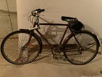 Full side view of the vintage Raleigh men's 5-speed bike showing frame, handlebars, saddle with under seat bag, fenders, and wheels.