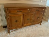 Front view of entire buffet showing three doors, single top drawer, reeded corners and tapered legs
