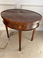 Front three-quarter view of entire table showing overall shape, leg style, and finish