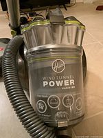 Close-up of Hoover WindTunnel Power Canister with visible branding and features including power nozzle, HEPA filter, and retractable cord.
