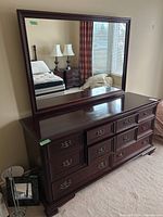 Front view of dresser with attached mirror showing finish and drawer arrangement.