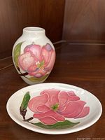 Overall view of the white bud vase and matching trinket dish with pink magnolia design.