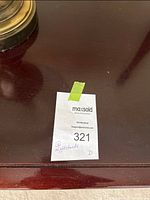 Top surface of one nightstand showing deep red-brown finish and MaxSold sticker #321