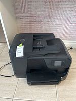 Front and top view of the HP OfficeJet Pro 8710 printer showing main body and automatic document feeder.