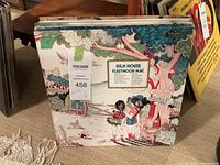 Stack of LP vinyl records with Fleetwood Mac 'Kiln House' record on top showing illustrated cover