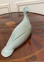 Side profile of smooth stone duck on wooden table