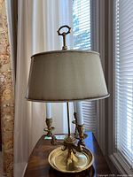 Full front view of the lamp showing base, arms, and shade