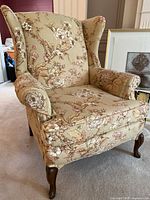 Front view of chair showing overall design, floral fabric pattern, rolled arms and removable seat cushion
