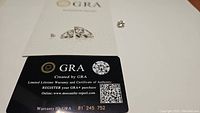 Certificate of authenticity and warranty card issued by GRA for the moissanite gemstone.
