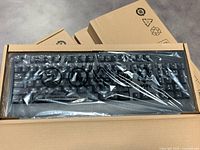 Five Lenovo Traditional USB wired keyboards in original sealed plastic wrapping inside cardboard boxes.