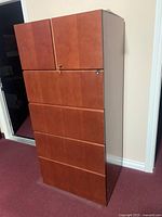 Full side and front view of the large wooden office cabinet showing its height and drawer layout.