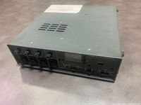 Front angled view showing metal enclosure, front panel connectors, knobs and switches