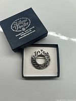 Front view of the Aitkens Pewter Celtic brooch in its original branded presentation box.