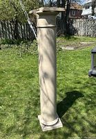 Front view of the tall rectangular stone pillar with natural stone color and weathered surface.
