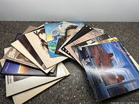 Top view of a spread of folk vinyl record album covers, showing different artists and colorful designs indicating folk music genre.