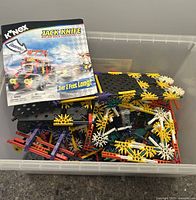 Plastic K'nex construction pieces in clear plastic container, with instruction manual for Jack Knife model included