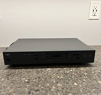 Front view of NAD Stereo Tuner 402 showing power button, tuning controls, and display which is not illuminated.