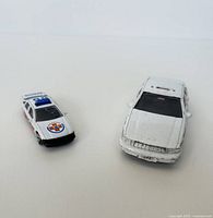 Photo showing both police car models side by side with white background