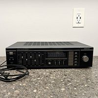 Front view of the SANYO JA 660-2 stereo integrated amplifier showing control panel with volume knob, power level indicators, function selector, and equalizer sliders.