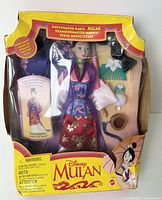 Front view of vintage Disney Matchmaker Magic Mulan doll in original yellow box with window display showing doll and accessories.