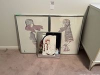 Photo of two large framed lithographs by A. Gruerio with a smaller framed mirror in front