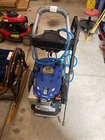 Front view of Subaru EA190V pressure washer on wheels with blue high-pressure hose and spray wand attached to handle.