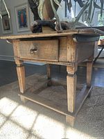 Front and side view showing single drawer, carved apron and stretcher base